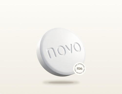 White Wegovy® Pill tablet with embossed novo mark floating above a soft shadow on a warm beige gradient
